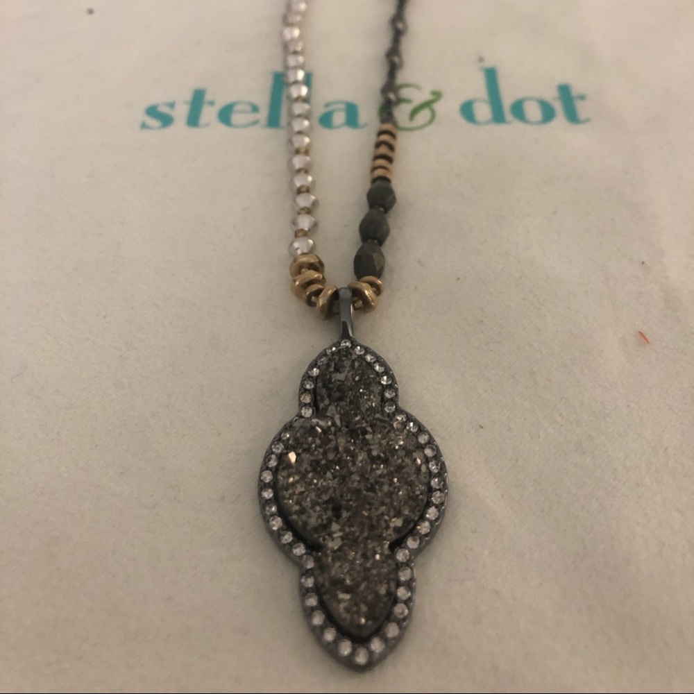 Long neutral beaded necklace.